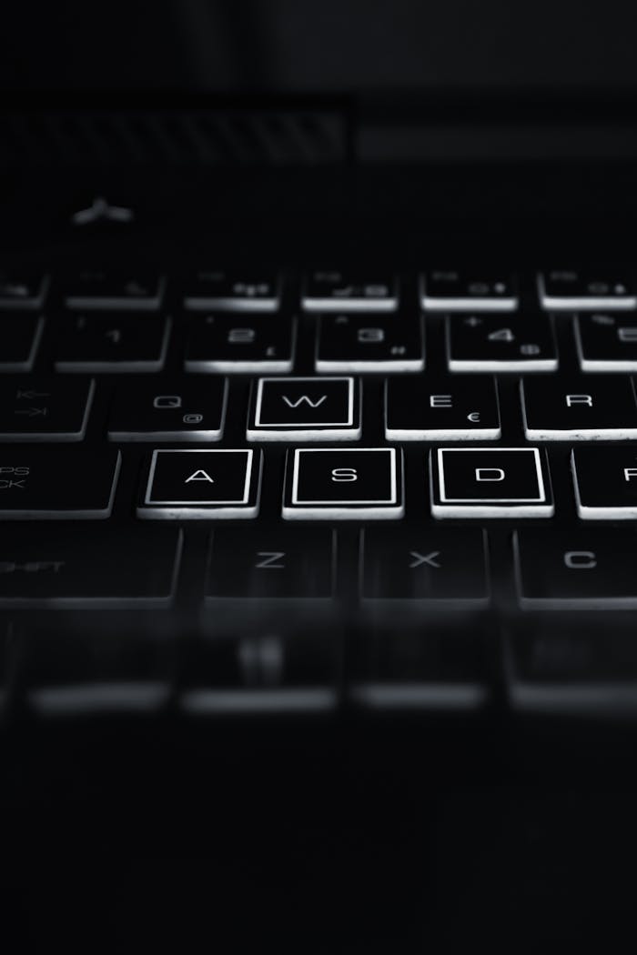 creative Close-up of a backlit laptop keyboard highlighting WASD keys. Perfect for technology themes.